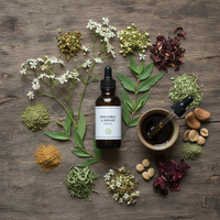 Bhringraj and brahmi hair oil ingredients — daisy flowers, brahmi leaves, amber bottle